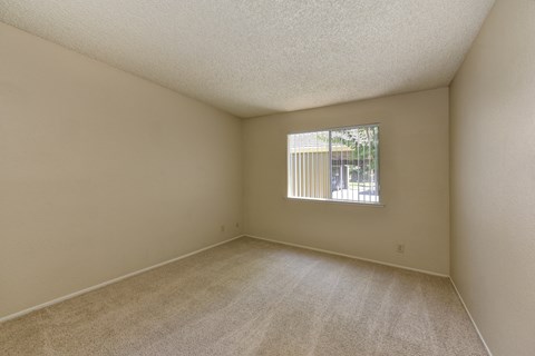 Empty Master Bedroom with Carpet, White Walls and Open Window